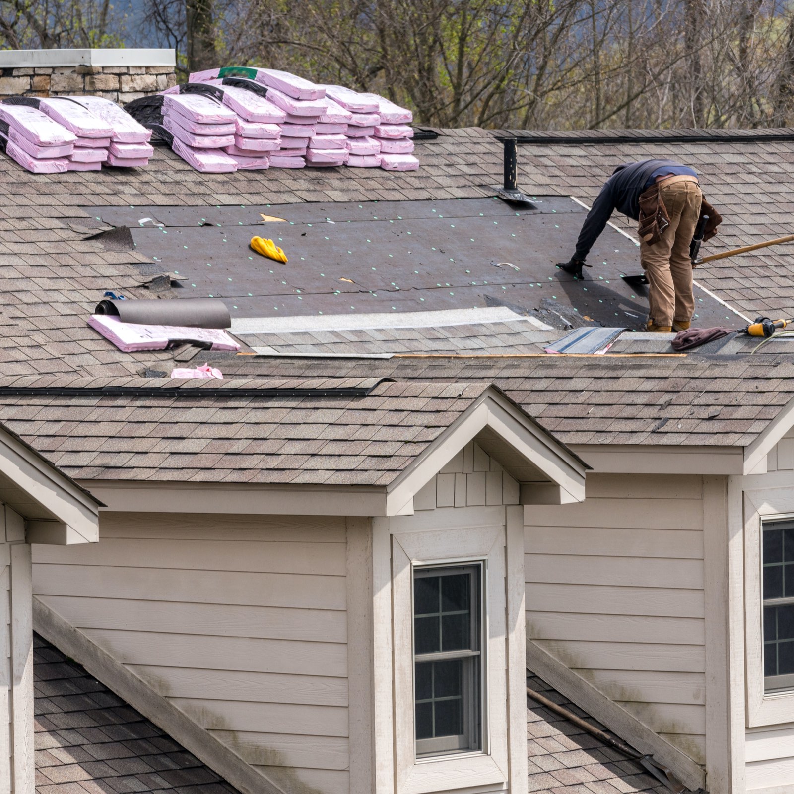 Houston roofer working on a Kingwood roof replacement with waterproof materials