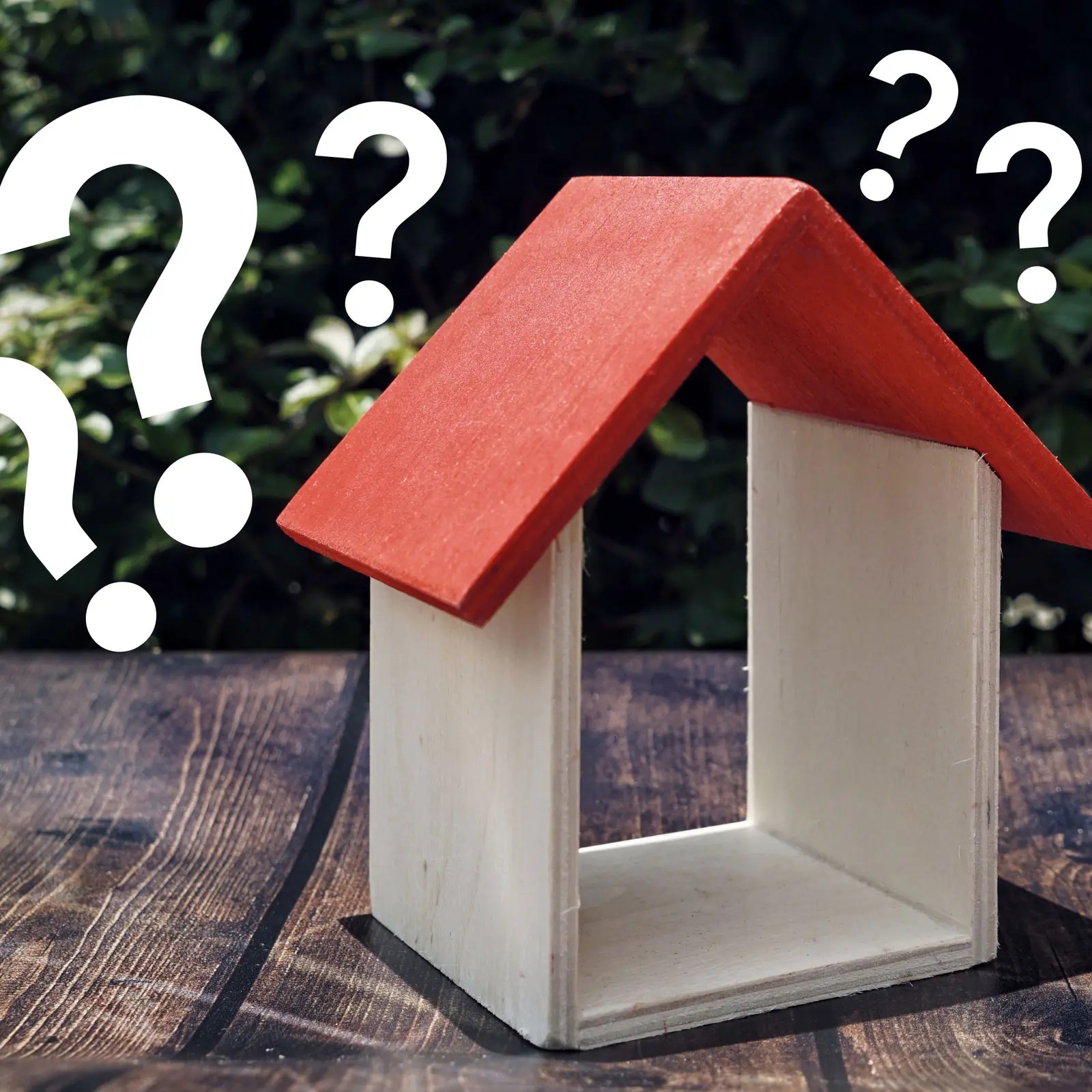Wooden blocks and question marks to signify jersey village roof replacement faqs