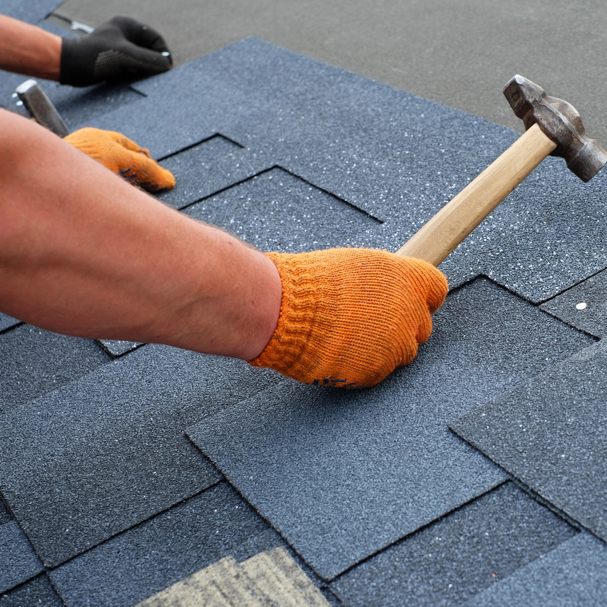 A Missouri City roofer placing shingles on a Missouri City roof replacement
